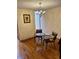 Cozy dining area with hardwood floors, a decorative brick wall, and an elegant chandelier at 7721 S Curtice Way # B, Littleton, CO 80120