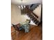 This dining area showcases a table with adjacent staircase with wood handrail at 7721 S Curtice Way # B, Littleton, CO 80120