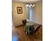 Cozy dining area features a chandelier and a decorative brick wall with a framed print at 7721 S Curtice Way # B, Littleton, CO 80120