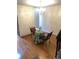 Cozy dining area features a modern chandelier, wood floors and light brick wall at 7721 S Curtice Way # B, Littleton, CO 80120