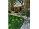 Charming brick home with a inviting front entrance and lush landscaping, featuring a 'For Sale' sign at 7721 S Curtice Way # B, Littleton, CO 80120
