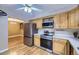 Bright kitchen features stainless steel appliances, wood floors, and light wood cabinets at 7721 S Curtice Way # B, Littleton, CO 80120