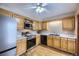 Bright kitchen features stainless steel appliances, wood floors, and light wood cabinets at 7721 S Curtice Way # B, Littleton, CO 80120