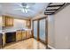 Bright kitchen features wood floors, wood cabinets, and sliding doors to backyard at 7721 S Curtice Way # B, Littleton, CO 80120