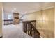 Second floor landing features a brick pillar, wood railing, and decorative lighting at 7721 S Curtice Way # B, Littleton, CO 80120