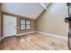 Bright living room with hardwood floors, a large window, and a vaulted ceiling, filled with natural light and charm at 7721 S Curtice Way # B, Littleton, CO 80120