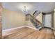 Bright living room with hardwood floors, a staircase, and a chandelier, offering an elegant and inviting space at 7721 S Curtice Way # B, Littleton, CO 80120