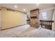 Spacious living room featuring a brick fireplace and neutral-toned walls and carpet at 7721 S Curtice Way # B, Littleton, CO 80120