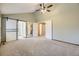 Spacious bedroom features a ceiling fan, neutral walls and carpeting, and closet doors at 7721 S Curtice Way # B, Littleton, CO 80120