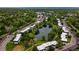 Aerial view of a community with a pond, apartments, parking lots, and trees at 190 E Highline Cir # 302, Centennial, CO 80122