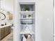 Bathroom shelves contain plants, toilet paper, and other items at 190 E Highline Cir # 302, Centennial, CO 80122