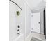 Bathroom tub and shower with marble pattern, white shower curtain, and shower head with leafy decoration at 190 E Highline Cir # 302, Centennial, CO 80122