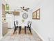 Dining room with tiled floors, adjacent to the kitchen with a stunning clock wall hanging at 190 E Highline Cir # 302, Centennial, CO 80122
