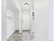 Apartment hallway with a front door, kitchen, tile floors, and shelving at 190 E Highline Cir # 302, Centennial, CO 80122