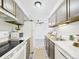 View of well-lit kitchen with white appliances and wood cabinets at 190 E Highline Cir # 302, Centennial, CO 80122