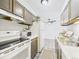 Bright kitchen offers ample counter space, wood cabinetry and white appliances at 190 E Highline Cir # 302, Centennial, CO 80122