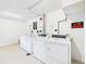 Laundry room with white washer and dryers and white floors at 190 E Highline Cir # 302, Centennial, CO 80122