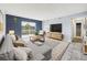 Bright living room with neutral carpet, blue accent wall, and sliding glass doors to a balcony at 190 E Highline Cir # 302, Centennial, CO 80122