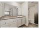 This bathroom features a shower-tub combination, stylish vanity, and attractive flooring at 6350 Oak St # 103, Arvada, CO 80004