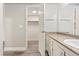 Bathroom vanity and walk-in closet with white walls and hardwood floors at 6350 Oak St # 103, Arvada, CO 80004