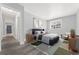 This primary bedroom features wood floors, natural light, and soothing light-blue colored walls at 6350 Oak St # 103, Arvada, CO 80004