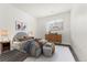 This primary bedroom features wood floors, natural light, and soothing white-colored walls at 6350 Oak St # 103, Arvada, CO 80004