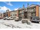 Apartment complex with balconies and parking lot dusted with snow at 6350 Oak St # 103, Arvada, CO 80004