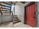 Exterior features a private entry with stairs leading to a red door at 6350 Oak St # 103, Arvada, CO 80004