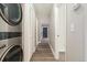 Hallway with a stackable washer and dryer and multiple storage options at 6350 Oak St # 103, Arvada, CO 80004