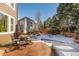 A well-kept backyard with a patio and seating area, surrounded by mature trees at 8850 W Cannes Dr, Littleton, CO 80127