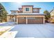 Stunning front exterior showcasing stone and wood siding with a two-car garage at 8850 W Cannes Dr, Littleton, CO 80127