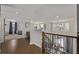 Upstairs hallway has hardwood floors, lots of light from large windows and a view of the home's lower level at 8850 W Cannes Dr, Littleton, CO 80127