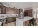 Well-equipped kitchen featuring wooden cabinets, stainless steel appliances, and an island at 8850 W Cannes Dr, Littleton, CO 80127