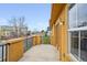 A balcony with black metal railing, window and door with a view of the neighborhood at 7777 E 23Rd Ave # 203, Denver, CO 80238