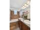 Bathroom boasts a double vanity, a tub with decorative tile, and ample lighting at 7777 E 23Rd Ave # 203, Denver, CO 80238