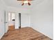 Bright bedroom boasts wood-look floors, ceiling fan, closet, and an open doorway at 7777 E 23Rd Ave # 203, Denver, CO 80238