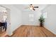 Inviting bedroom with wood-look flooring, a ceiling fan, and ample natural light from multiple windows at 7777 E 23Rd Ave # 203, Denver, CO 80238