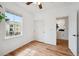 Bedroom featuring wood-look floors, ceiling fan, closet, and natural light from a window at 7777 E 23Rd Ave # 203, Denver, CO 80238
