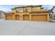 Modern townhome showcasing individual garages and balconies in a vibrant community at 7777 E 23Rd Ave # 203, Denver, CO 80238