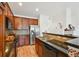 Contemporary kitchen featuring cherry cabinetry, stainless steel appliances, and a breakfast bar with seating at 7777 E 23Rd Ave # 203, Denver, CO 80238