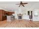 Open-concept living space with a kitchen, fireplace, and stairs leading to the upper level at 7777 E 23Rd Ave # 203, Denver, CO 80238