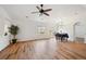 Spacious living room with hardwood floors, natural light, and views of the outdoor balcony area at 7777 E 23Rd Ave # 203, Denver, CO 80238