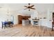 Open concept space includes hardwood floors, kitchen with breakfast bar, living room, and adjacent dining area at 7777 E 23Rd Ave # 203, Denver, CO 80238