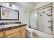 Classic bathroom features a granite counter, framed mirror, and shower-tub combo at 5995 W Hampden Ave # 2G, Denver, CO 80227