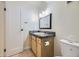 Bathroom with granite countertop vanity, updated fixtures, and a crisp white door at 5995 W Hampden Ave # 2G, Denver, CO 80227