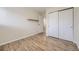 A bright bedroom featuring sleek hardwood floors and a spacious closet at 5995 W Hampden Ave # 2G, Denver, CO 80227