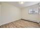 Bright bedroom features a window with blinds, and wood flooring at 5995 W Hampden Ave # 2G, Denver, CO 80227