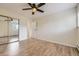 Bright bedroom featuring wood floors, large closet, and ceiling fan at 5995 W Hampden Ave # 2G, Denver, CO 80227