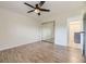Bedroom featuring wood floors, closet, and doorway to another space at 5995 W Hampden Ave # 2G, Denver, CO 80227