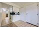 Inviting entryway features tile flooring, white cabinets, and access to other rooms at 5995 W Hampden Ave # 2G, Denver, CO 80227